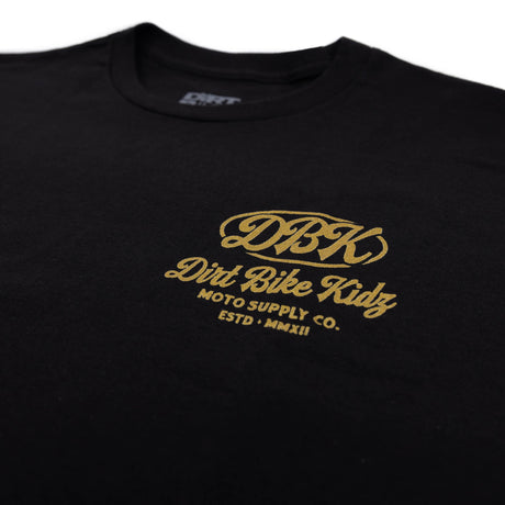 Gold Nugget Tee: close-up of black front logo with gold “Dirt Bike Kidz”