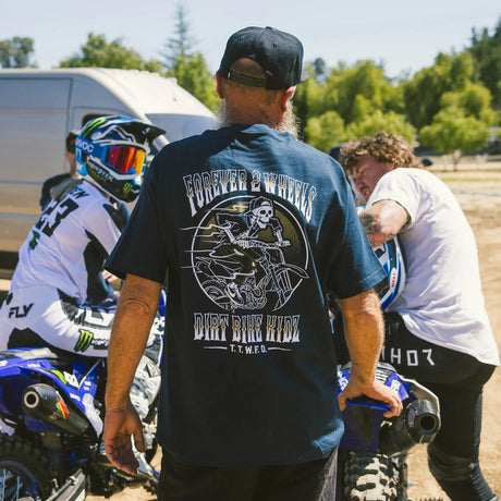 Ghost Rider Tee worn by model from the back, black, with circular Dirt Bike Kidz skull rider graphic