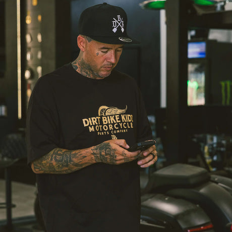Black Gold Standard tee worn, front logo graphic visible